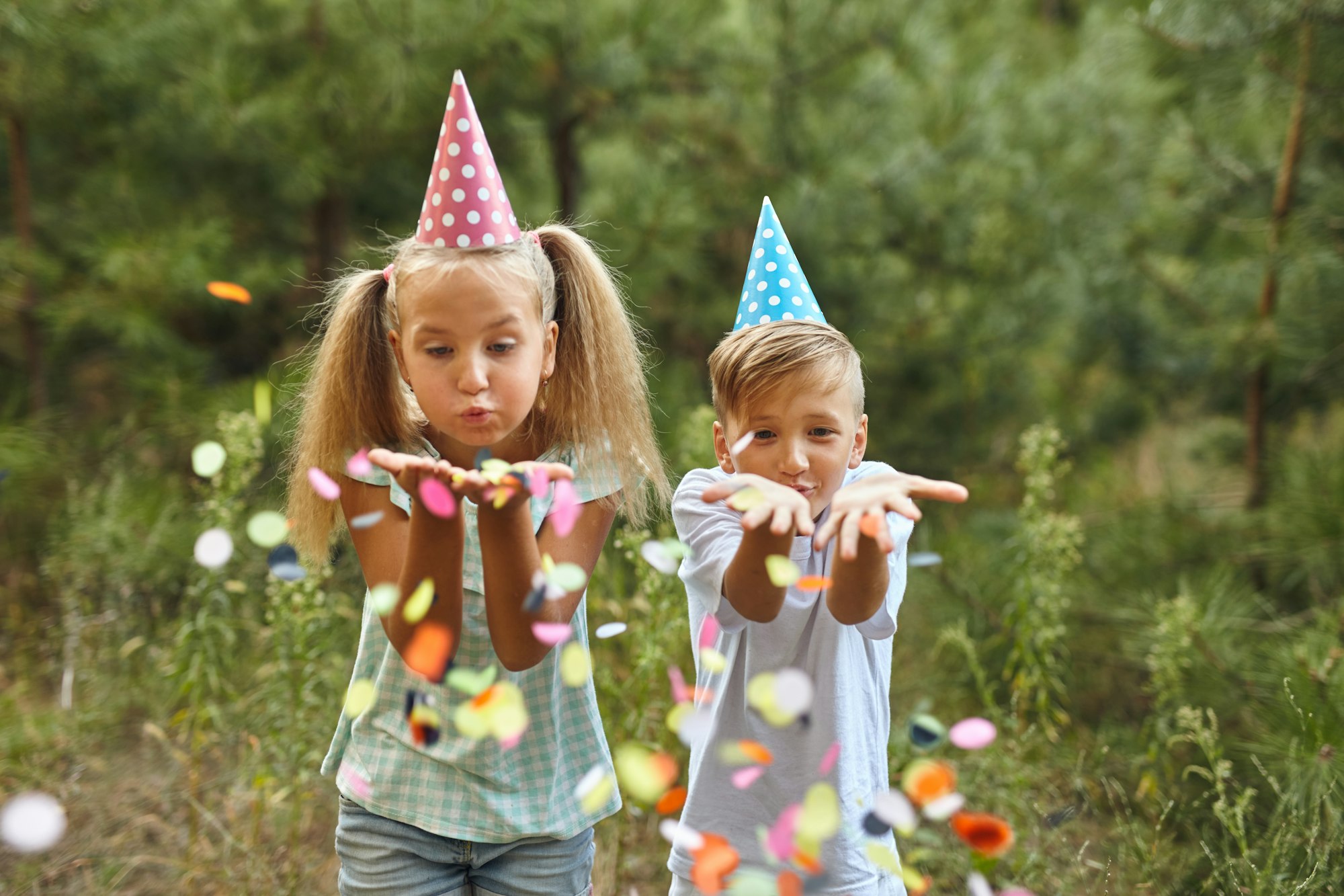 happy birthday children with confetti on outdoor bithday party