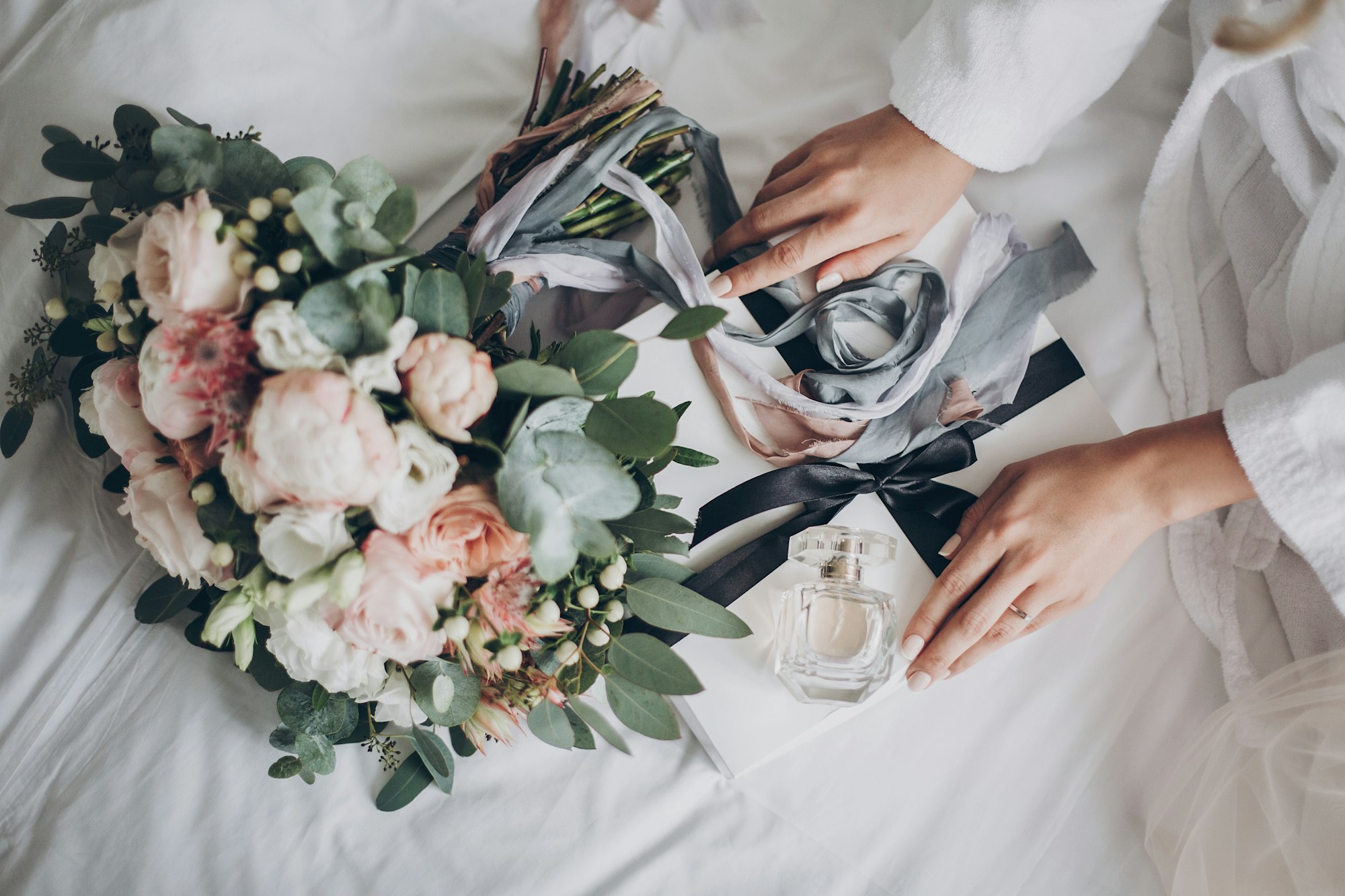 Modern wedding bouquet, perfume bottle, and gift box